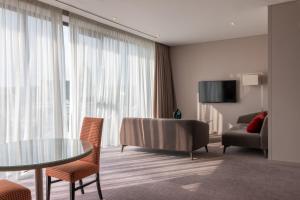 a hotel room with a table and chairs and a couch at Whites of Wexford in Wexford