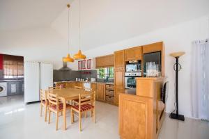 a kitchen with a table and chairs and a refrigerator at Holiday Villa in Balaclava