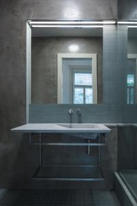 a bathroom with a sink and a mirror at Hotel Golden Lamb in Karlovy Vary +30 photos