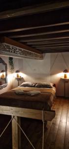 a bedroom with a bed with two lamps on the wall at SIKATE Hospitality in Mýkonos City