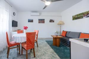 a living room with a table and a couch at Holiday Home Casa Blu near the Beach in Neum