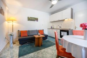 a living room with a couch and a table at Holiday Home Casa Blu near the Beach in Neum
