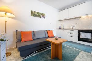 a living room with a couch and a table at Holiday Home Casa Blu near the Beach in Neum +14 photos