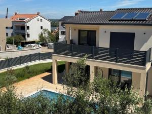 a house with solar panels on the roof at Villa Mario in Poreč