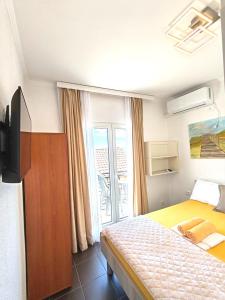 a hotel room with a bed and a window at Guest House Lara in Neum