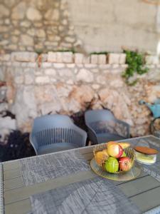 a table with two plates of fruit on it at Guest House Lara in Neum +14 photos