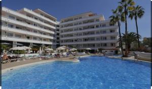 a large swimming pool in front of a hotel at Luxury unique central flat with 2 swimming pools in Playa de las Americas