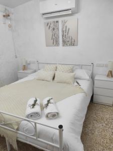 a bedroom with a white bed with towels on it at Bosquet de l'Auró in Argençola +64 photos
