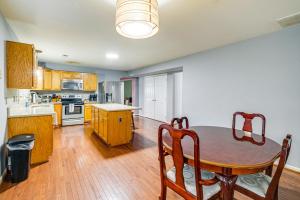 a kitchen with a wooden table and a dining room at Family Retreat with Fenced Yard in Woodbridge! in Woodbridge