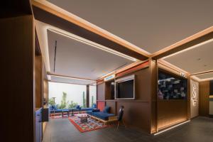 a living room with a couch and a television at 三贵三六酒店 Three Rich Hotel in Changsha