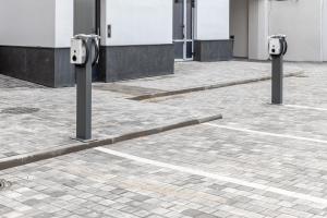 a row of parking meters on a brick street at Gatve apartment in Rīga +2 photos