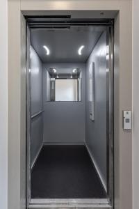 a hallway with a door leading into a room at Gatve apartment in Rīga