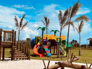 a playground on the beach with palm trees at Casa Pillar - Casa de Alto Padrão em Ilhéus in Ilhéus
