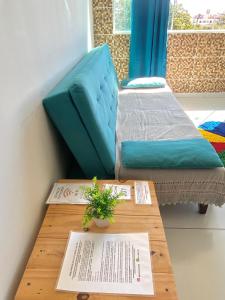 a room with two beds and a table with pamphlets at Flat JACUMÃ LITORAL SUL PB in Jacumã +30 photos