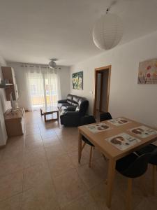 a living room with a couch and a table at Pool Center in Caudete