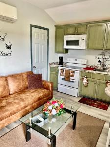 a living room with a couch and a kitchen at Charming two bedroom duplex apartment in Autaugaville +16 photos