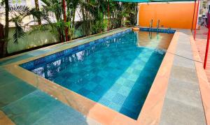a large swimming pool with a blue at Golden bliss Resort and Pool in Nagaon