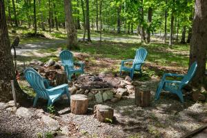 a group of blue chairs sitting around a fire pit at Dog-Friendly w Hot Tub, Fire Pit & River Access in Great Cacapon