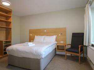 a hotel room with a bed and a chair at Pebble Path at Marine Court in Littlehampton +52 photos