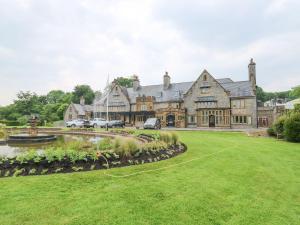 a large house with a pond in front of it at Pebble Path at Marine Court in Littlehampton