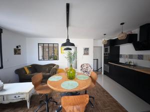 a kitchen and living room with a table and chairs at L'ATELIER YPORT in Yport