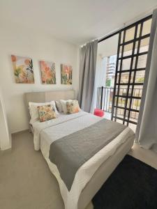 a bedroom with a large bed and a large window at Le MARIE B&B in Cartagena de Indias +65 photos