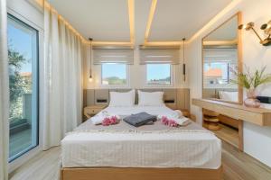 a bedroom with a large bed with flowers on it at Luxury Villa Fotini in Limenas +115 photos