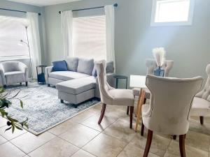 a living room with a couch and a table and chairs at Cozy 2 Bedroom home, Dade City! in Dade City