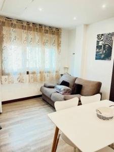 a living room with a couch and a table at Sky 403 by CONFORTSKY in Pas de la Casa