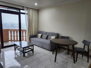 a living room with a couch and a table at Riverbank Suites Kuching Waterfront in Kuching