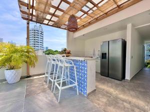 a kitchen with a stainless steel refrigerator on a balcony at Le MARIE B&B in Cartagena de Indias