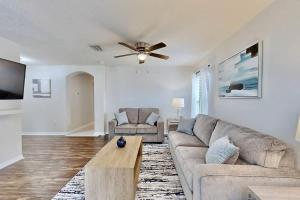 a living room with a couch and a ceiling fan at Brooksville Retreat! 3 Bed, 2 Bath! in Brooksville