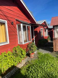 a red house with some plants in front of it at Caza azul salto del laja in Los Ángeles