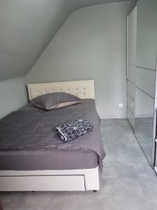a bedroom with a bed with a gray comforter at Appartement im weißen Haus in Moers