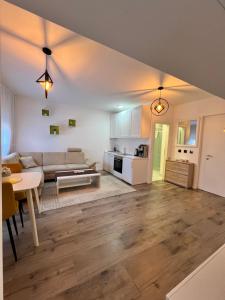 a living room with a couch and a table at Apartmani Gandi in Bihać