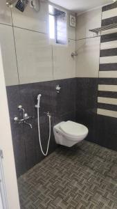 a bathroom with a toilet and a shower at Comfort Inn in Tirunelveli