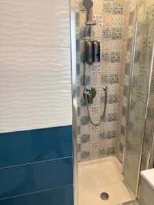 a shower in a bathroom with a glass door at Casa Maria in Anacapri