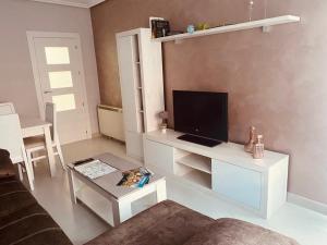 a living room with a tv and a white entertainment center at Casa esperanza in Soria