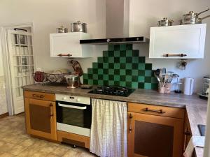 a kitchen with a stove and a counter top at Maison de vacances Bazas in Lignan-de-Bazas