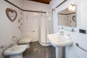 a bathroom with two sinks and a shower and a toilet at Italian Experience-Dafne Suite in Pavia +24 photos