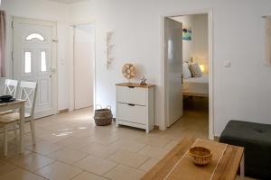 a living room with a couch and a table at Jenny Sam renovated house for 5 near center and be in Skiathos Town +19 photos