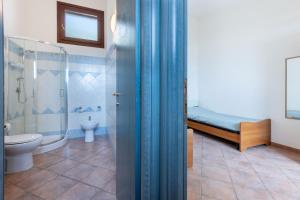 a bathroom with a shower and a toilet and a sink at GuestHost - Bedà House in Porto Carollo +43 photos