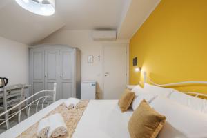 Postel nebo postele na pokoji v ubytování Sa Domu Colorada- Eleganza e comfort nel centro di Villasimius