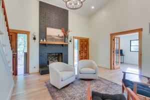 a living room with two chairs and a fireplace at Nature Escape - Pond, Dock, Fire Pit, Trails in Paris
