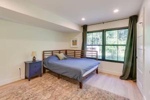 a bedroom with a bed and a window at Nature Escape - Pond, Dock, Fire Pit, Trails in Paris