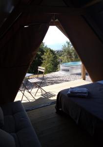 a view of a tent with a bed and a tub at Glamping - La Giara in San Demetrio Corone
