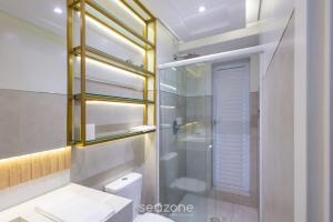 a bathroom with a toilet and a glass shower at Apto 2Q c/ churrasq. prox da praia - BC - STL401 in Balneário Camboriú +13 photos