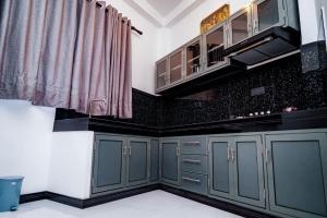 a kitchen with green cabinets and a sink at Elegance Lake View in Habaraduwa Central