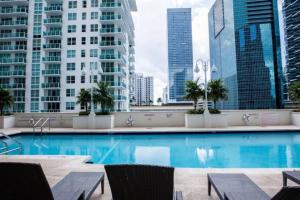 a swimming pool in a city with tall buildings at Exclusive 2BR APT Brickell Free Parking in Miami