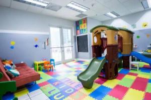 a play room with a slide and a couch at Exclusive 2BR APT Brickell Free Parking in Miami